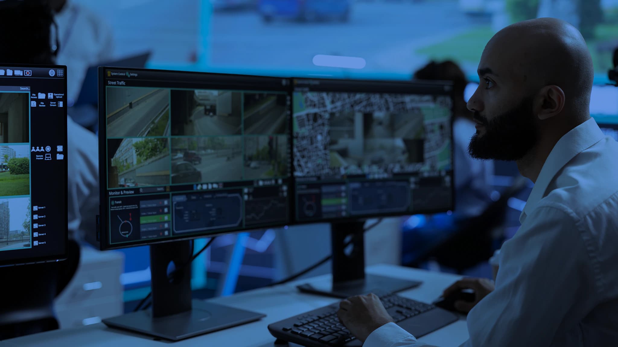 Professionals reviewing road safety data on monitors